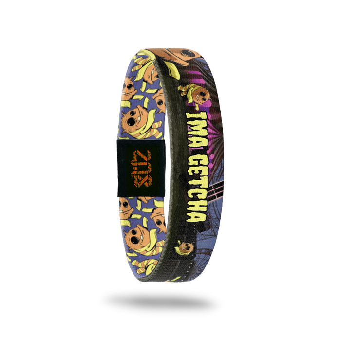 Product photo of the inside of 2020 - Day 23 - Ima Getcha: abandoned carnival design with orange and yellow striped monsters with long yellow arms, one eye smaller than the other, and one tooth with yellow 'IMA GETCHA' text