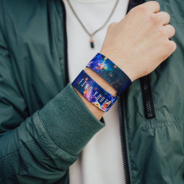 Lifestyle close up image of model's wrist wearing 2 Find Your Light straps