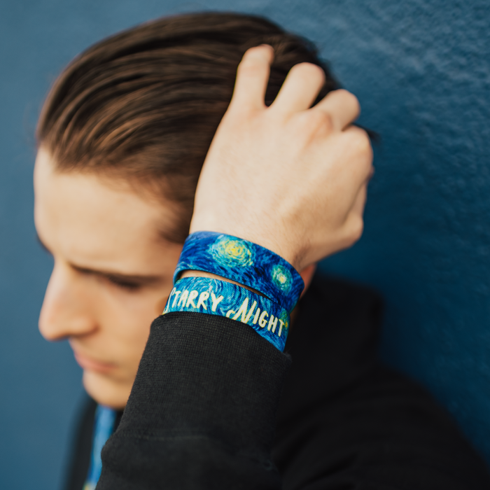 Lifestyle close up image go model fixing their hair and wearing two Starry Night straps