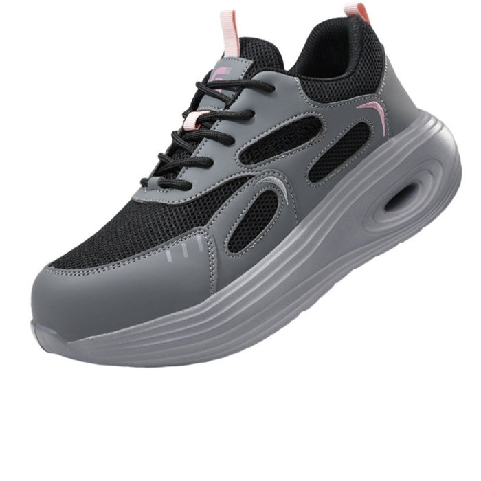 Side profile of SafeStep women's grey fashion safety sneakers, featuring a breathable mesh upper, athletic cushioned sole, and protective steel toe for all-day comfort.