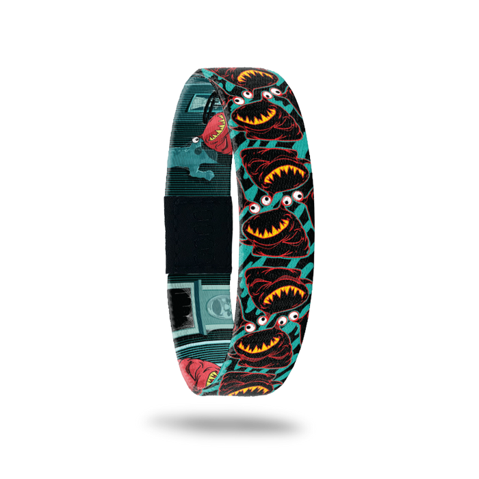 Product photo of the outside of 2020 - Day 20 - Ms. Oh That's Nice: turquoise and black design with repeating black and red monster with sharp yellow teeth and one eyeball