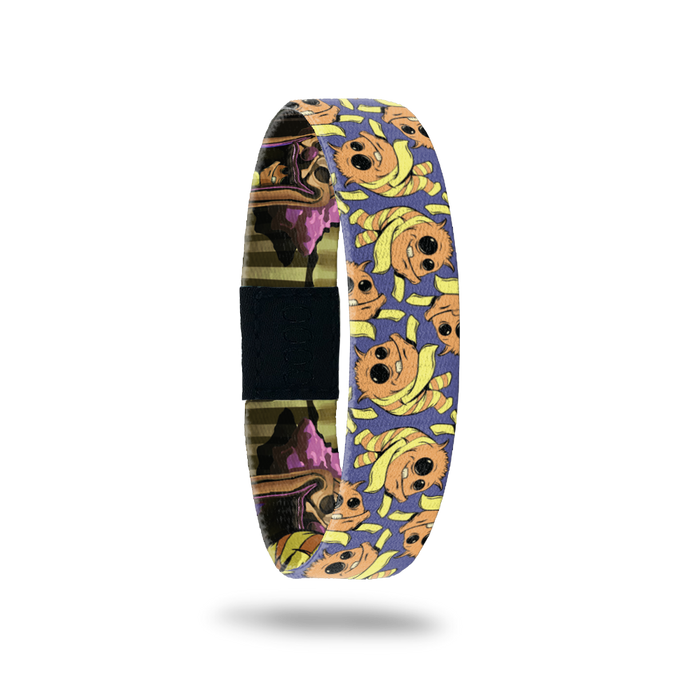 Product photo of the outside of 2020 - Day 23 - Ima Getcha: purple design with repeating orange and yellow striped monster with long yellow arms, one eye smaller than the other, and one tooth