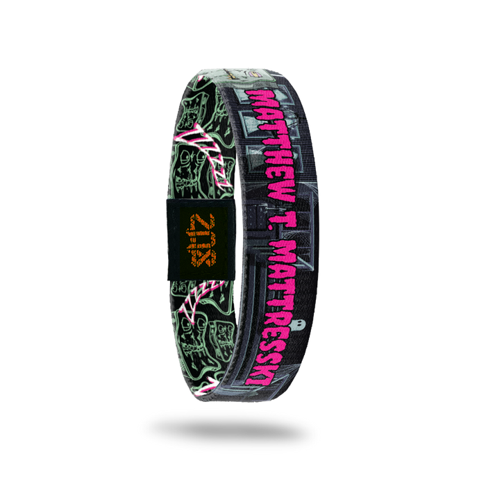 Product photo of the inside of 2020 - Day 27 - Matthew T. Mattresski: haunted house design with pale blue and mint green mattress monster with eyes and a mouth and pink 'MATTHEW T. MATTRESSKI' text