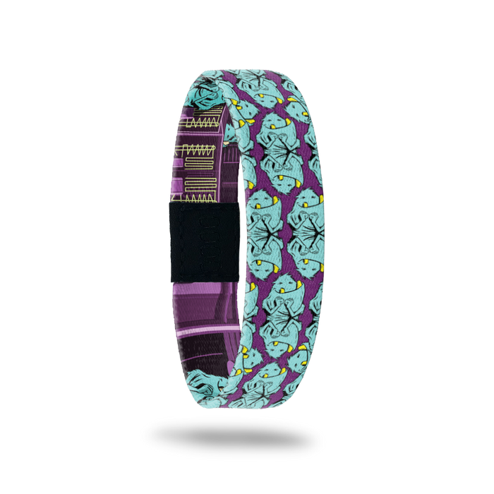 Product photo of the outside of 2020 - Day 3 - Oh Boy: purple design with repeating furry, turquoise smiling monster with two yellow teeth