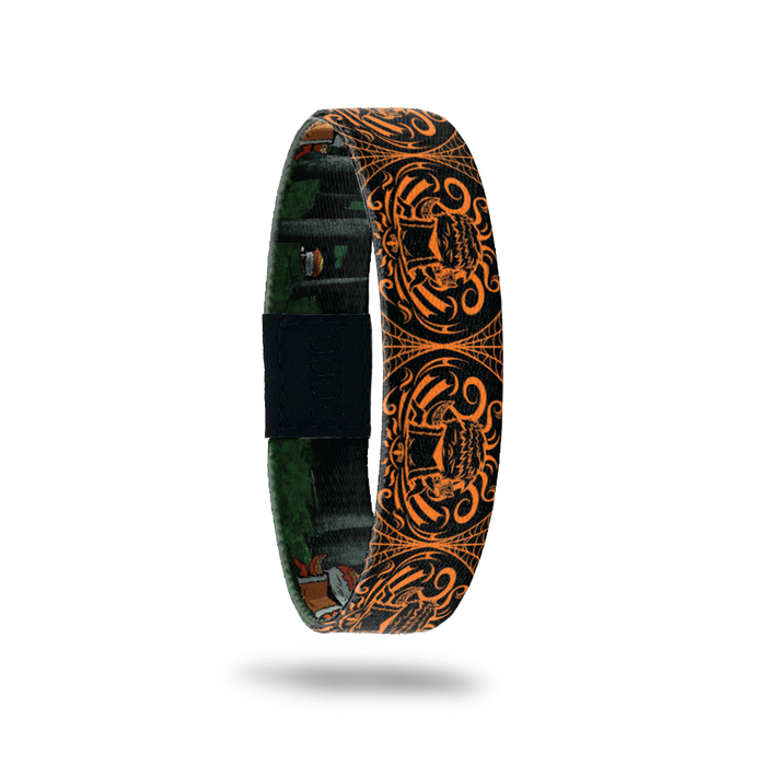 Product photo of the outside of 2020 - Day 4 - Zennifer: black and orange design with repeating orange furry monster with 4 tentacles holding a coffee cup