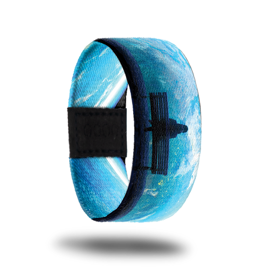 Product photo of the outside of 2020: blue toned design with artwork of a person sitting on a park bench looking at the world from outer space