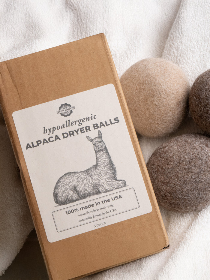 Rustic Strength - Alpaca Dryer Balls ( 3 pack ) beside its packaging