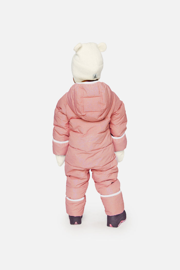 Back view of a baby standing in the pale dusty pink Deux par Deux Baby Cloud snowsuit