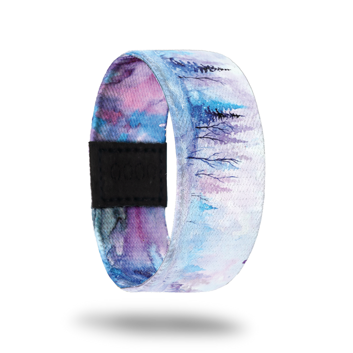 Be Still My Soul-Sold Out-ZOX - This item is sold out and will not be restocked. White snowy background with blue and pink pine trees in the background. Inside is blue, pink and purple watercolor and says Be Still My Soul.