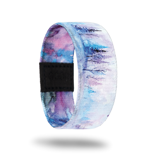 Be Still My Soul-Sold Out-ZOX - This item is sold out and will not be restocked. White snowy background with blue and pink pine trees in the background. Inside is blue, pink and purple watercolor and says Be Still My Soul.
