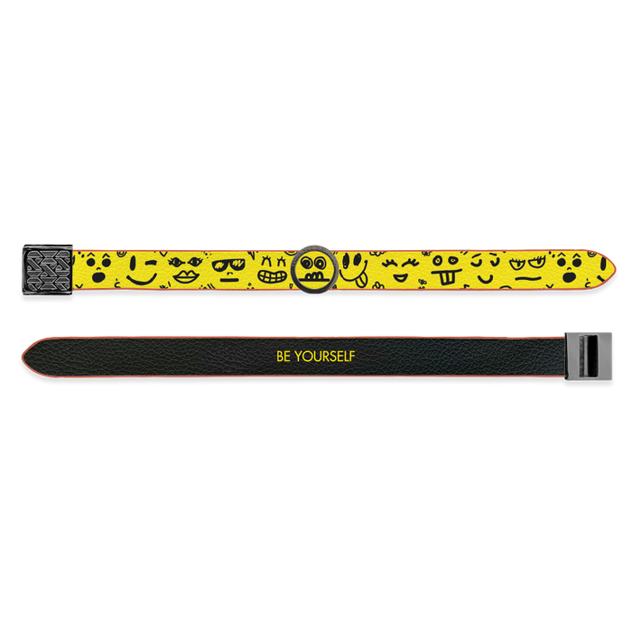 Outside Design of the V2 Imperial Be Yourself: vegan leather material with printed on design yellow background with different facial expressions, marked by a gunmetal circular charm and gunmetal buckle clasp. And Inside Design of the V2 Imperial Be Yourself: vegan leather material with printed on design black background with black text ‘Be Yourself’ and gunmetal buckle clasp