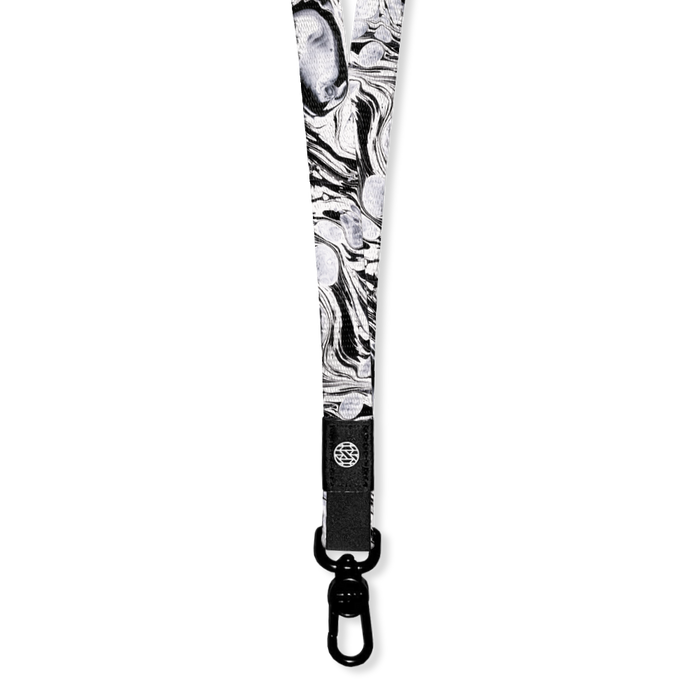 White with black marbling all over. Inside says Believe In Yourself. Comes with a pull hook clamp for keys/cards.