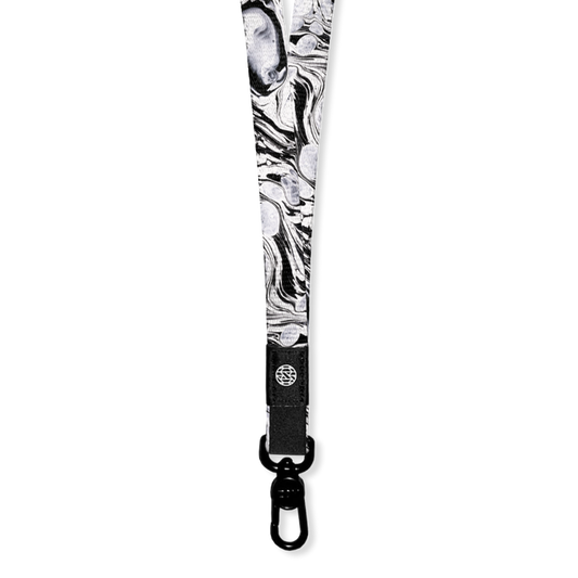 White with black marbling all over. Inside says Believe In Yourself. Comes with a pull hook clamp for keys/cards.