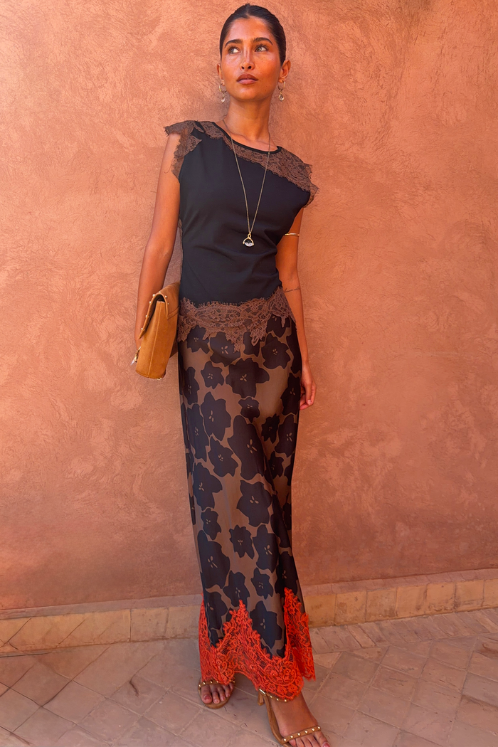Black and Chocolate Lace Jersey Top with brown lace trim and Persi floral skirt, a London look against a terracotta wall.