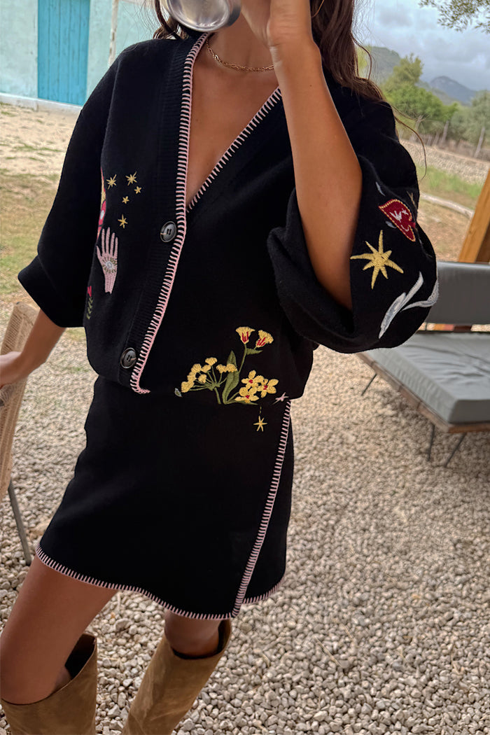 Black Night Garden Mini Wrap Skirt with pink blanket stitch and night garden motifs, styled as a matching co-ord.