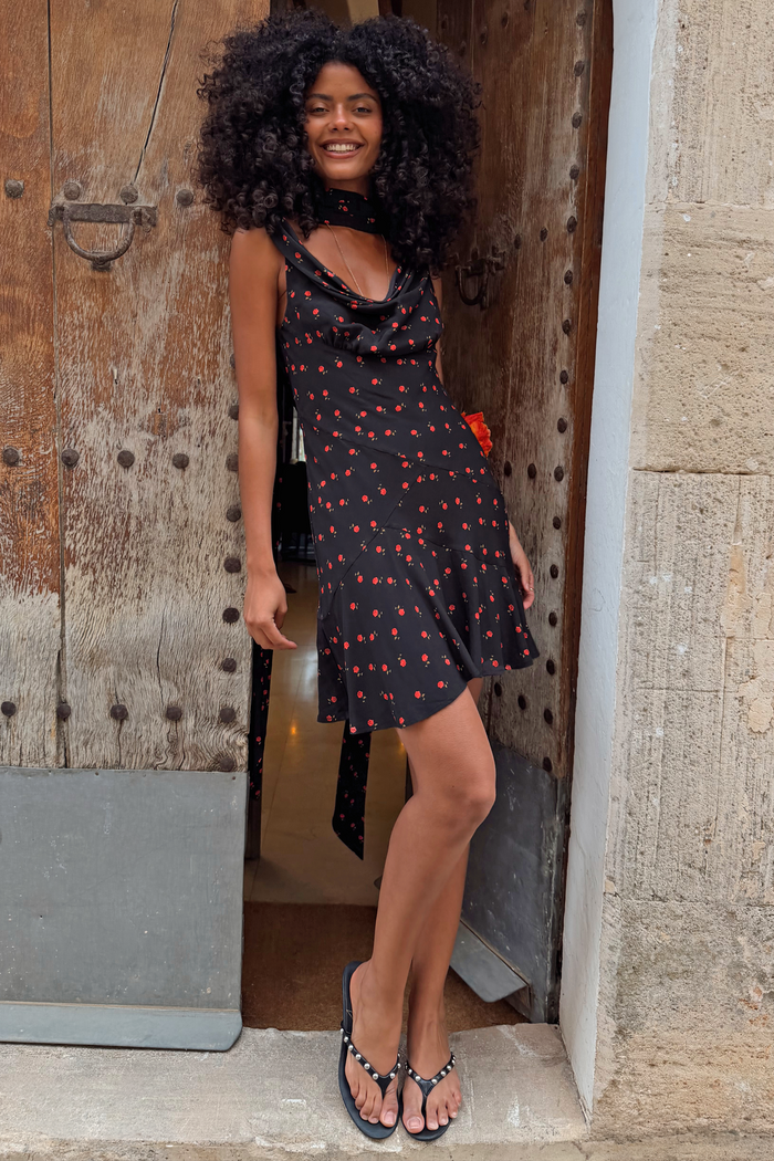 Black Rose Mini Sophie Dress with a red rose print, cowl neckline and matching scarf detail on a model.