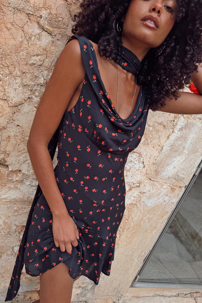 Black Rose Mini Sophie Dress featuring a red rose print, cowl neckline and neck scarf, designed in London.