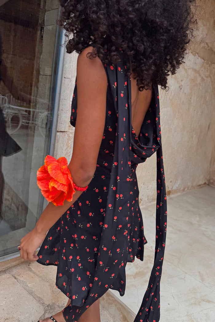 Bias-cut Black Rose Mini Sophie Dress with a red rose print, featuring a cowl back and multi-wear scarf detail.