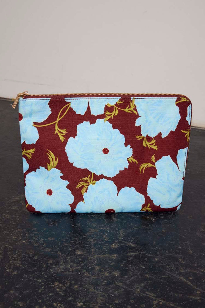 Blue & Burgundy Poppy Laptop Case featuring oversized light blue florals on a burgundy background with a gold zip.