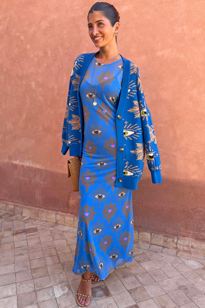 Blue Eye Mesh Dress featuring heart and eye motifs, layered with a matching knit cardigan in a bold blue tone.