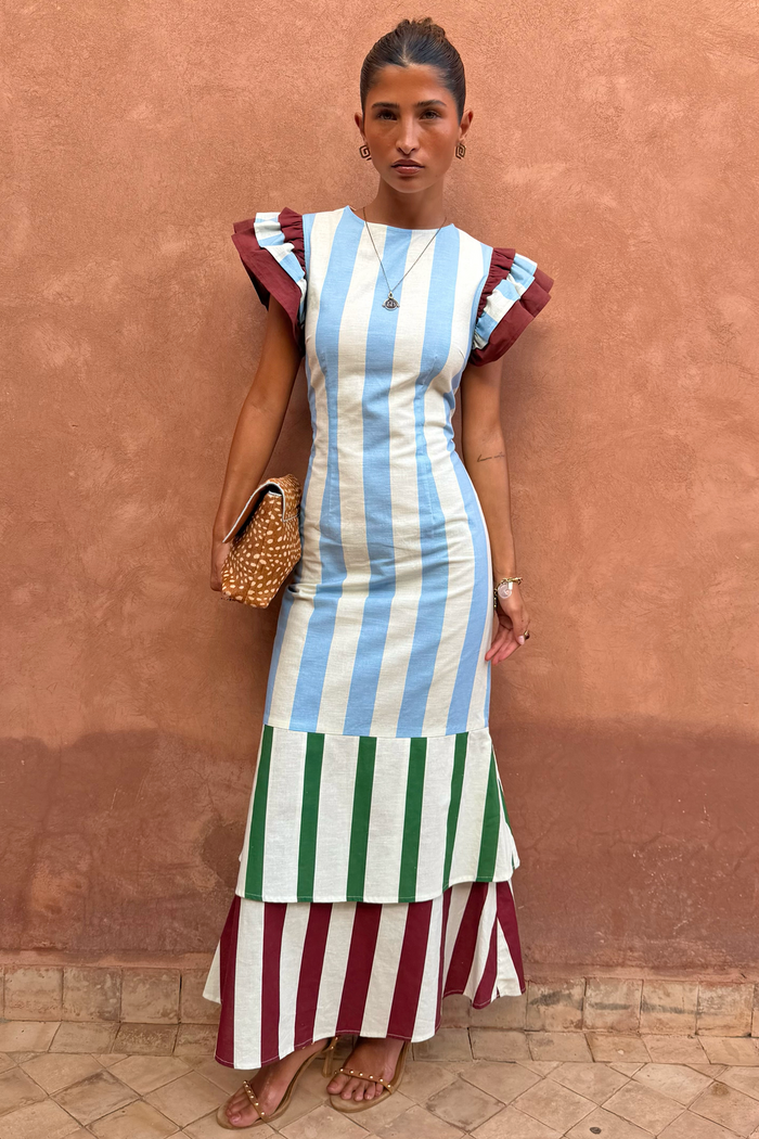 Blue Stripe Alena Midi Dress with green and burgundy tiered stripes and frill sleeves on a model.