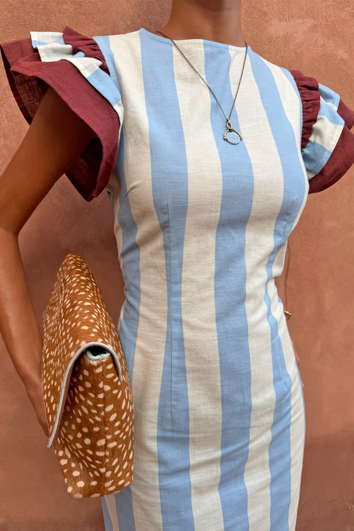 Blue Stripe Alena Midi Dress with vertical stripes and burgundy frill sleeves, styled with a leopard print clutch.