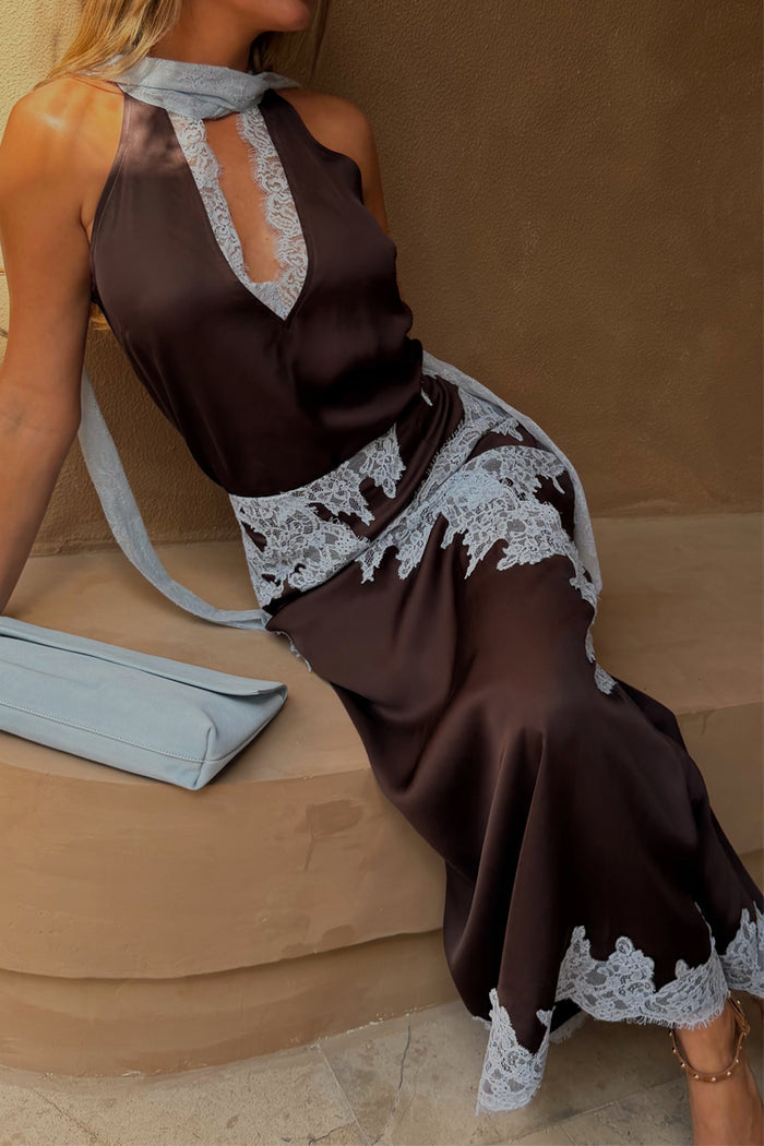 Chocolate Lily Skirt in brown satin with blue lace trim, styled with a matching top and a blue clutch bag.