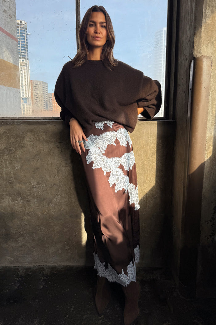 Chocolate Lily Skirt in brown satin with pale blue lace panels, styled with a dark brown oversized sweater.