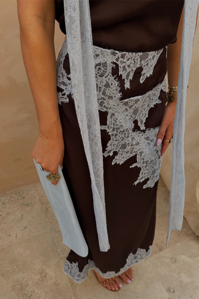 Chocolate Lily Skirt in brown satin featuring light blue lace detailing and a matching clutch.