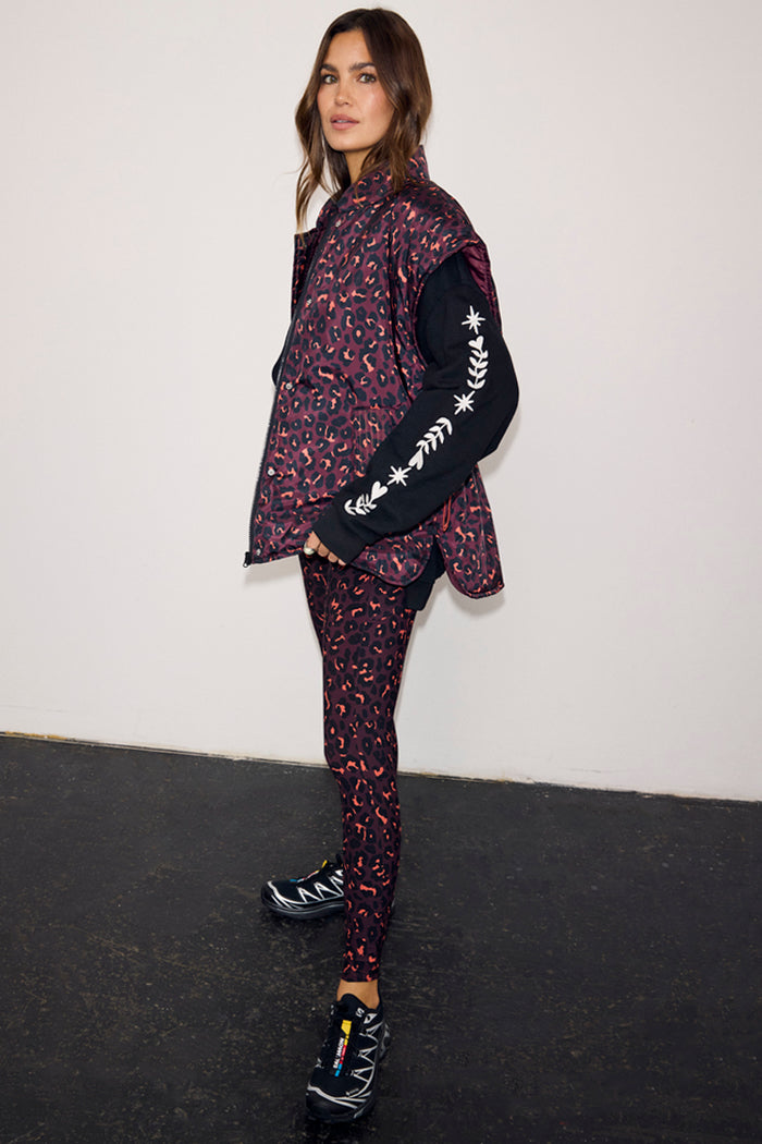 Dark Leopard Gilet with a padded funnel neck, styled with matching leggings and a black long-sleeve top.