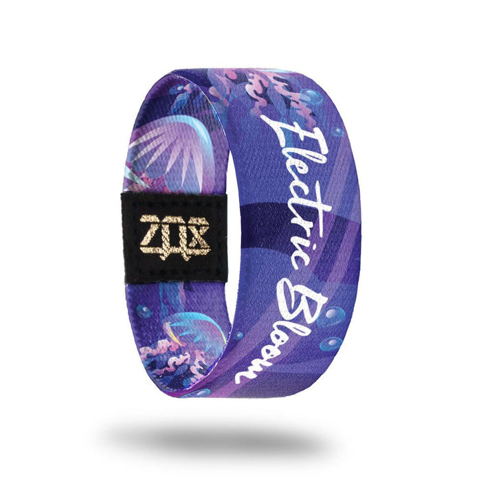 Inside design of Electric Bloom. Shades of purple background with blue illustrated bubbles and illustrated jellyfish that are purple with blue highlights. Centered in the design is Electric Bloom in white text
