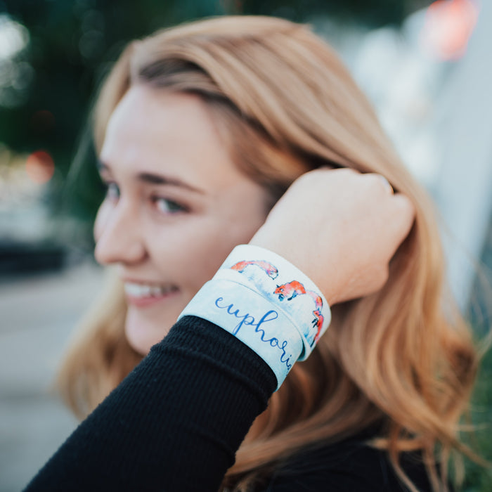 Lifestyle close up image go model fixing their hair and wearing two Euphoria straps
