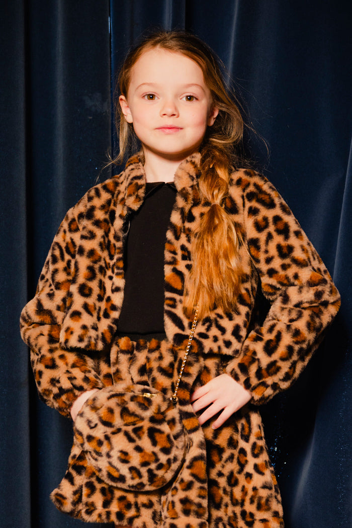 Girl in the Deux par Deux brown leopard print faux fur jacket with a matching leopard bag