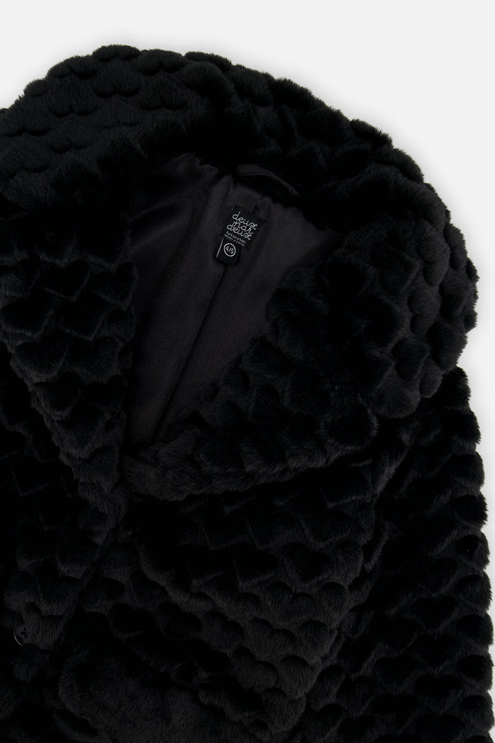 Close-up of the black faux fur collar with textured heart pattern and the lining