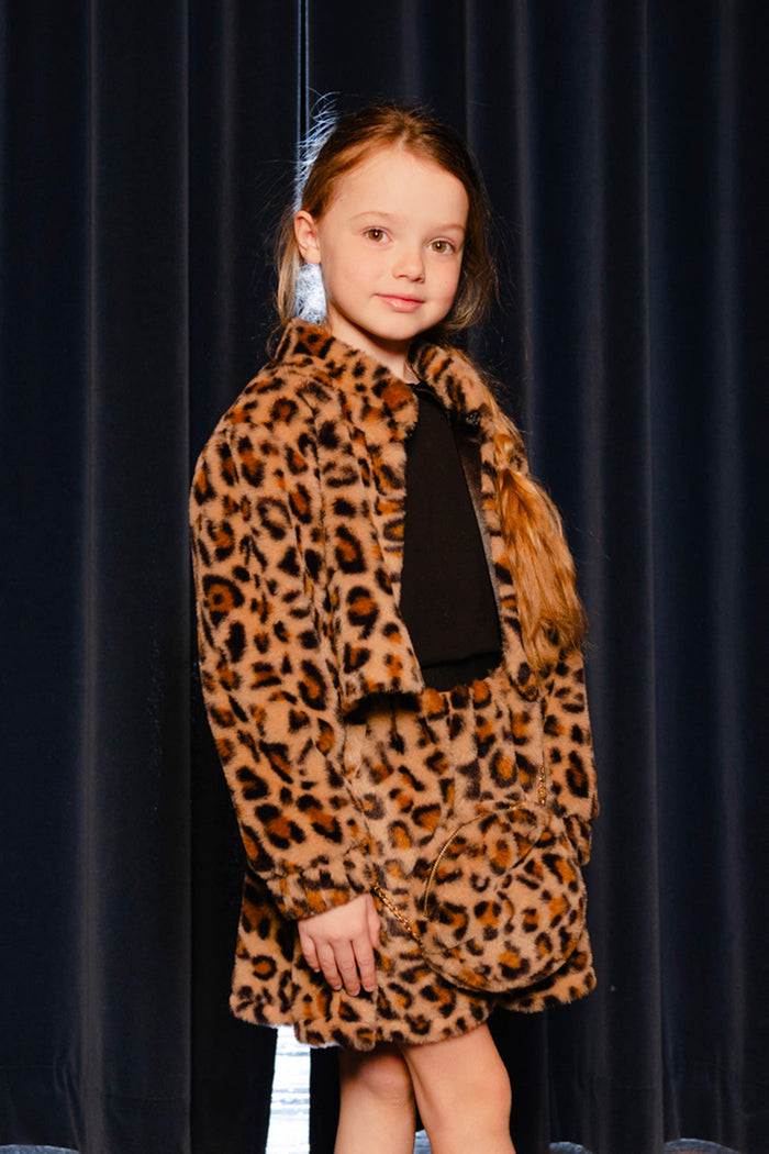 Child carrying the Deux par Deux leopard print faux fur shoulder bag