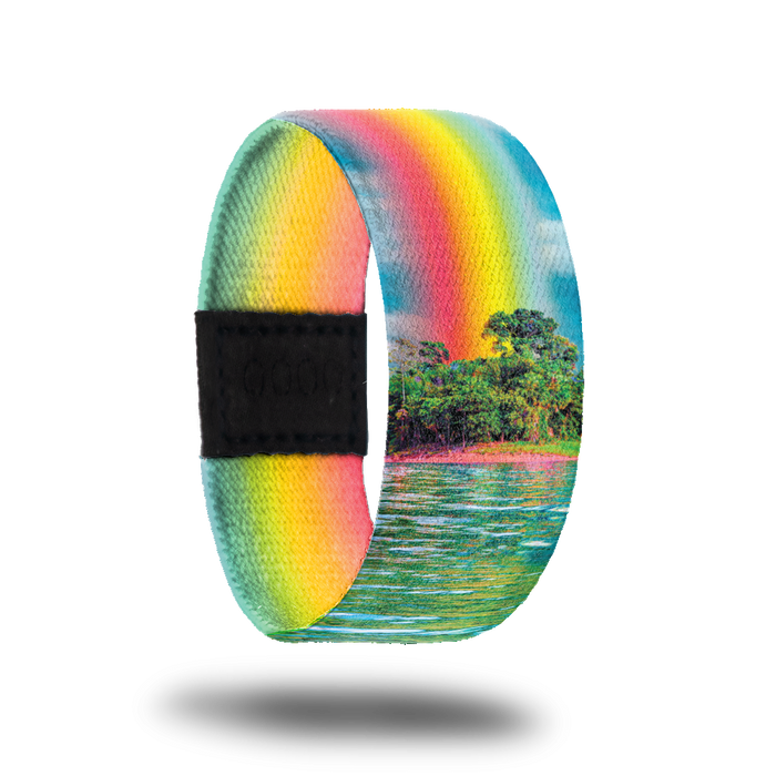 Outside Design of Find Your Bliss: island with ocean water in front of it and with a rainbow beaming into the sky above