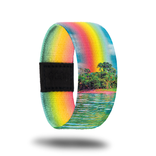 Outside Design of Find Your Bliss: island with ocean water in front of it and with a rainbow beaming into the sky above
