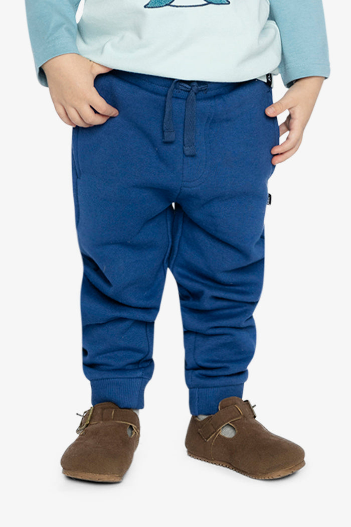Child wearing Deux par Deux fleece jogger sweatpants in blue, lookbook view 1