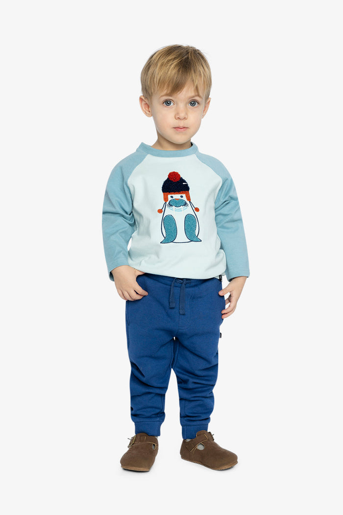 Child wearing Deux par Deux fleece jogger sweatpants in blue, full outfit lookbook view