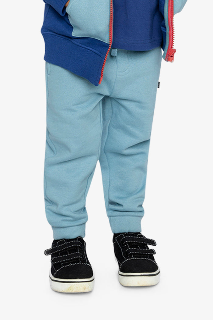 Child wearing Deux par Deux fleece jogger sweatpants in pale turquoise, lookbook view 1