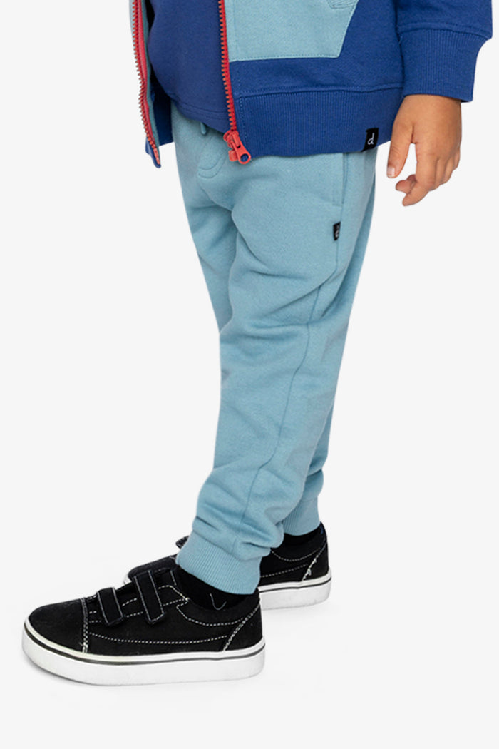 Child wearing Deux par Deux fleece jogger sweatpants in pale turquoise, lookbook view 2