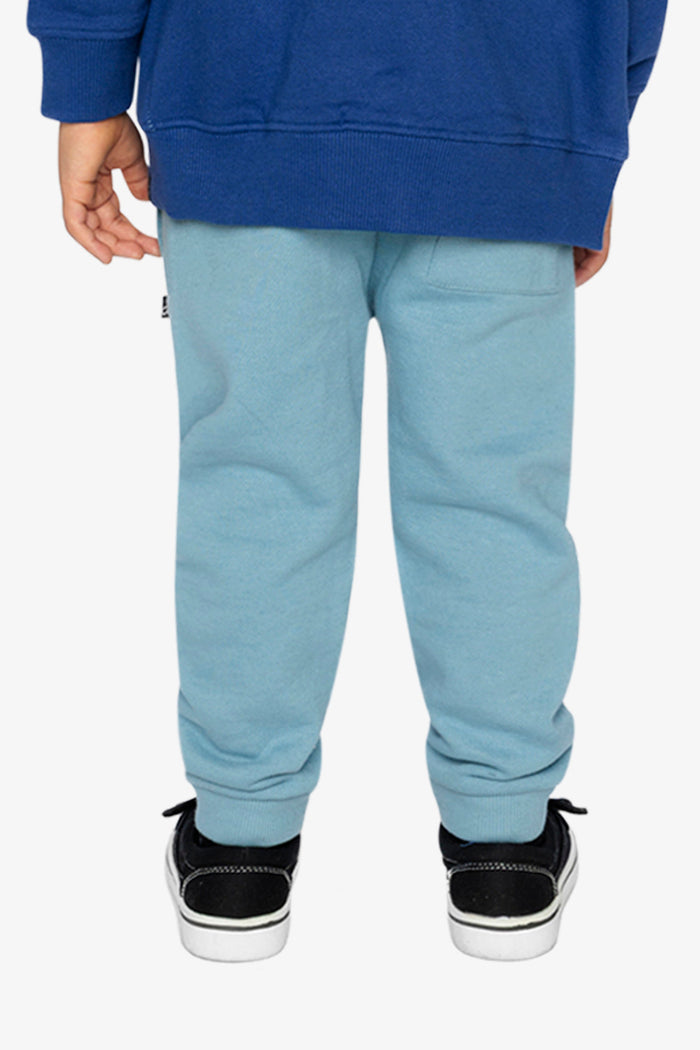 Child wearing Deux par Deux fleece jogger sweatpants in pale turquoise, lookbook view 3