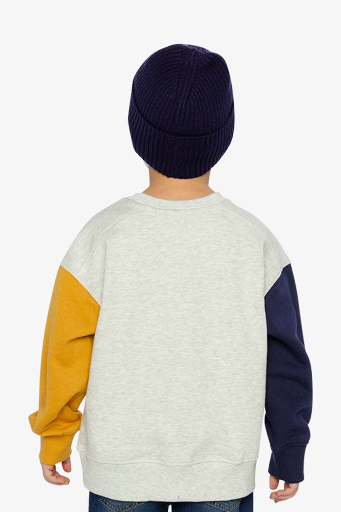 Child wearing Deux par Deux fleece sweatshirt in heather grey, yellow and blue with smiley face graphic, lookbook view 3