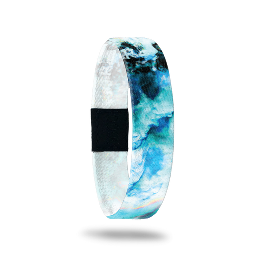 Wristband with a blue, teal, black and white marble design. Inside reads Focus On The Positive.