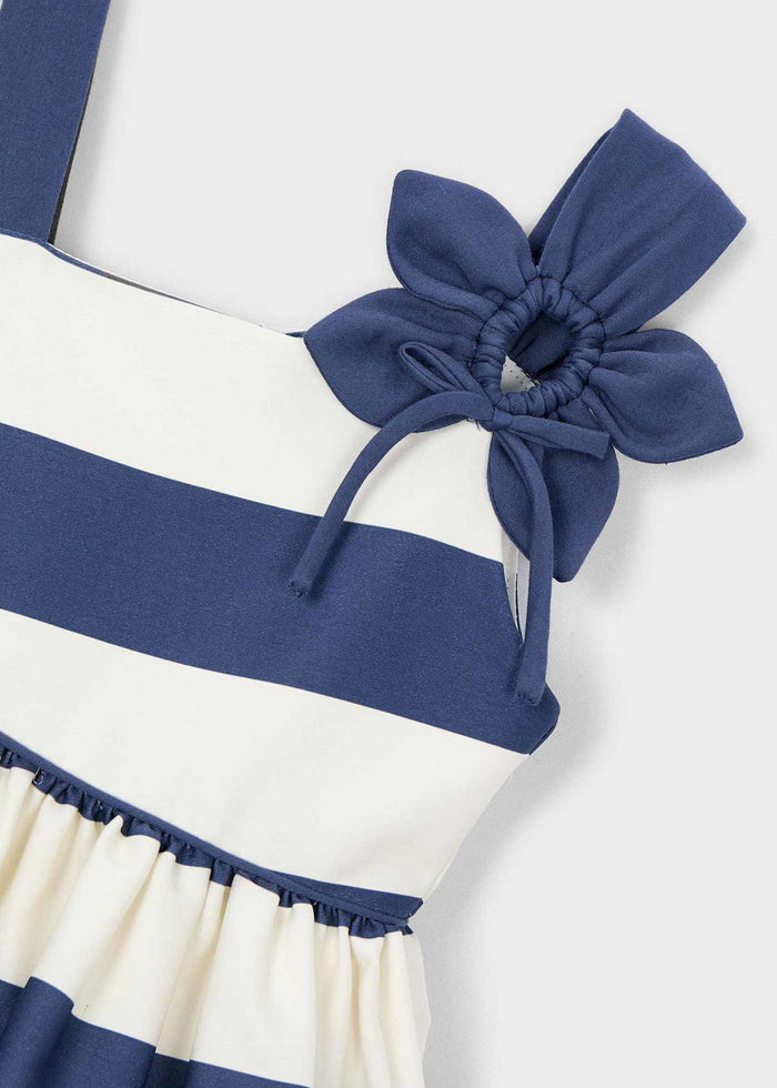 Close-up of navy fabric flower and striped bodice on girls dress