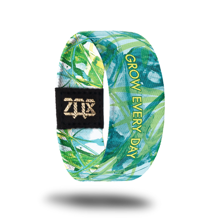 Inside design of Grow Every Day. Illustration of plant life in green and light blue colors with Grow Every Day centered in yellow text