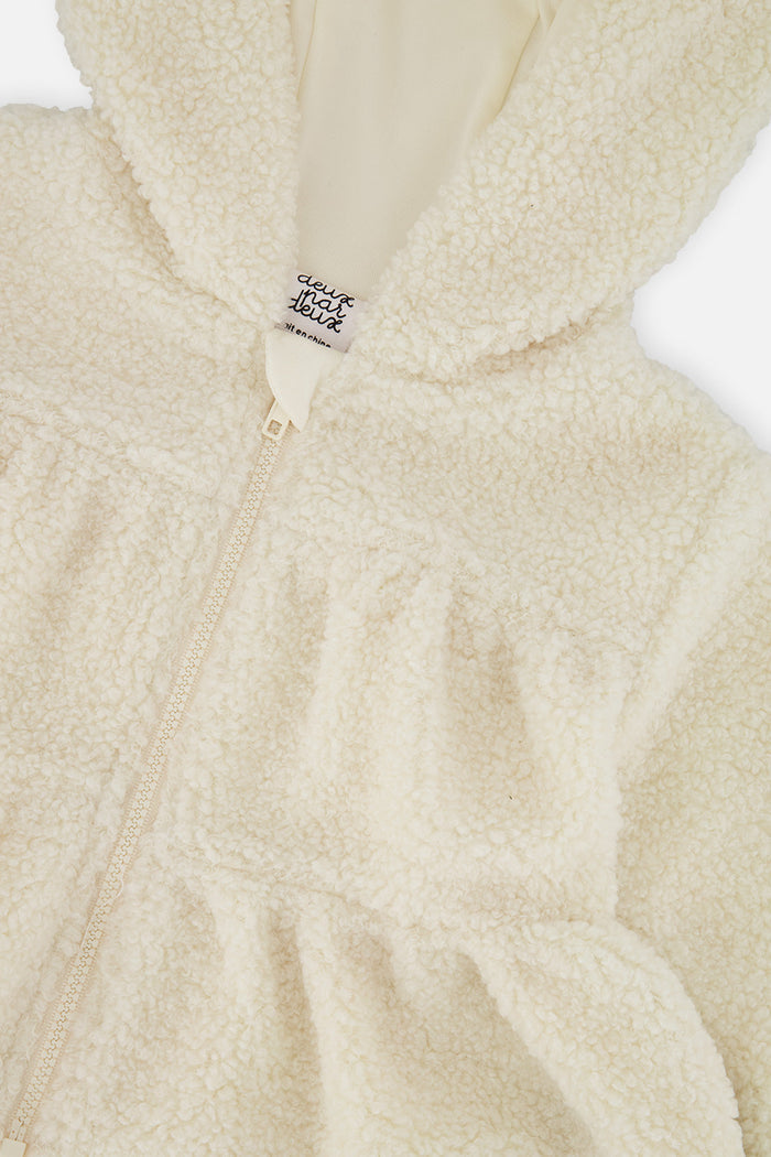 Close-up of the full zip and tiered front of the off-white baby sherpa jacket