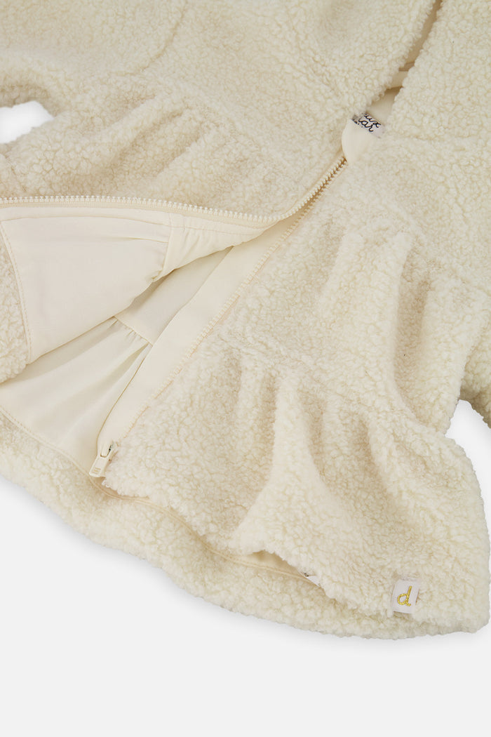 Close-up of the lining and tiered hem of the Deux par Deux baby girls sherpa jacket