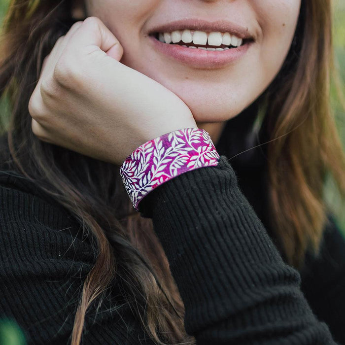 Studio close up image of smiling model and Hope Over Fear on their wrist