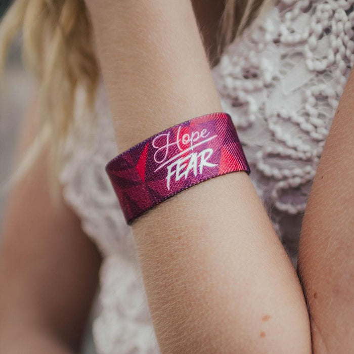 Lifestyle close up of Hope Over Fear on someone's wrist